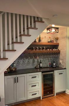 a kitchen with an oven, sink and shelves under the stairs in front of it