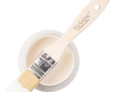 a white paint brush in a bowl with the word fluson on it's side