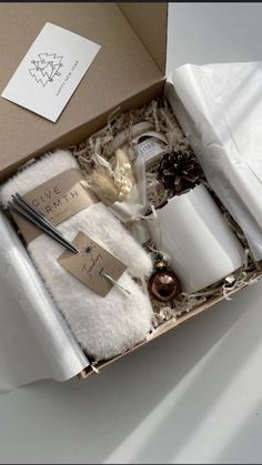 an open box containing candles and other items