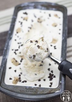 an ice cream sundae with chocolate sprinkles is being scooped into it