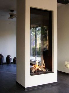 a modern fireplace in the middle of a living room