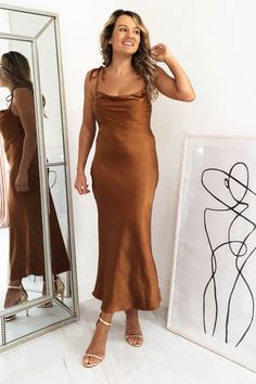 Approx length: 110cm Cowl neckline True to size Silky Stretchy fabric  100% Polyester Colour: Rust Care: Hand was only - Iron inside out on low heat Model is wearing size 8 Model is 5'3 height Copper Bridesmaid Dresses, Brown Satin Dress, Brown Silk Dress, Mocha Dress, Rust Color Dress, Oh Hello Clothing, Brown Bridesmaid Dresses, Rust Bridesmaid Dress, Silk Bridesmaid Dresses