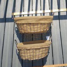 two baskets sitting on top of a wooden floor