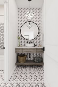 a bathroom with a sink, mirror and tiled flooring in black and white colors