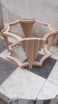 a wooden bench sitting on top of a cement slab