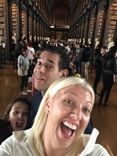 a group of people standing around each other in a library