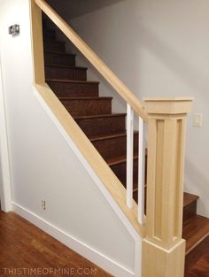 an empty room with stairs and hard wood flooring on the bottom part of the staircase