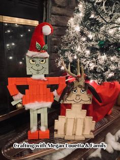 two legos made to look like santa and reindeer