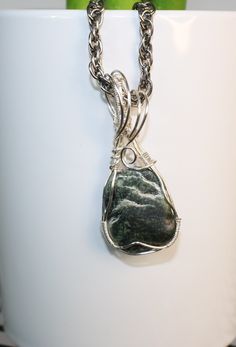 This pendant is made of a serpentine stone wrapped in silver jewelry. If you look closely on the markings of the stone you can see a Mountain View. The pendant is 2 inches tall and 1 inch wide and it weighs .25 of an ounce Silver Wire Wrapped Moss Agate Necklace, Nickel-free Moss Agate Silver Jewelry, Nickel-free Silver Moss Agate Jewelry, Jade Wire Wrapped Pendant Jewelry, Serpentine Stone, Stone Wrapping, Silver Jewelry, Jewelry Necklace Pendant, Jewelry Necklaces