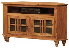 a wooden entertainment center with glass doors