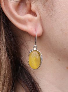 Oval earrings in natural Baltic amber, set in sterling silver setting. Natural cloudy untreated color stone. All dimensions are in the description. Weight = 8.8 gram Amber Oval Jewelry With Matching Earrings, Cabochon Amber Earrings For Gift, Amber Cabochon Earrings For Gifts, Oval Baltic Amber Jewelry With Polished Finish, Oval Sterling Silver Earrings With Polished Finish, Classic Oval Baltic Amber Jewelry, Amber Cabochon Earrings Gift, Sterling Silver Oval Cabochon Earrings, Classic Yellow Oval Earrings