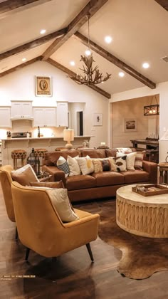 a living room with couches, chairs and a coffee table in front of a fireplace