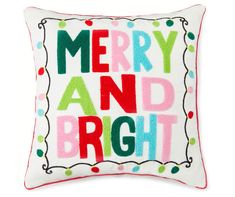 a merry and bright pillow on a white background