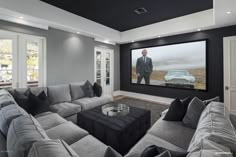 a living room filled with furniture and a flat screen tv mounted to the side of a wall