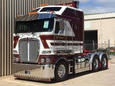 a large semi truck parked in front of a building