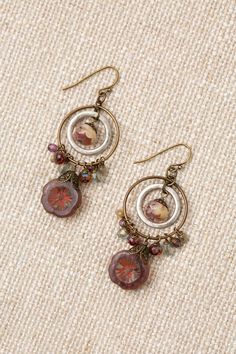 The Czech Glass Collection offers a varied selection of handcrafted earrings, including this unique statement design. Antique Brass (Lead & Nickel Free) Czech Glass 2.25" with antique brass ear wires We hand select our natural materials, thus there may be slight variations in color and/or size that will not detract from the overall aesthetic. Our unique handcrafted designer jewelry for women is made in America, each design created individually in our personal design studio in Floyd, VA USA Floyd Va, Silver Gold Earrings, Silver Gold Necklace, Flower Hoop Earrings, Czech Glass Jewelry, Simple Collage, Handcrafted Earrings, Crafted Jewelry, Gold Collection