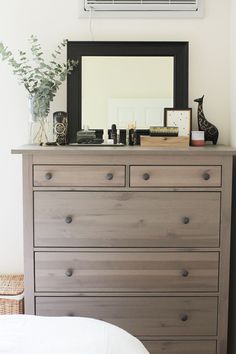 a dresser with drawers and a mirror on top