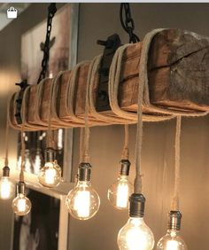 some light bulbs hanging from a wooden beam