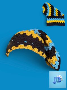 a crocheted hat and banana on a blue background