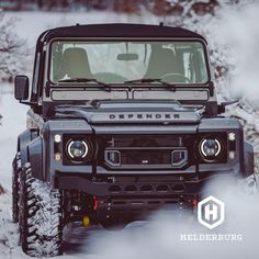 the defender vehicle is driving through the snow