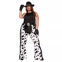 a woman dressed as a cowgirl in black and white pants, top hat and gloves