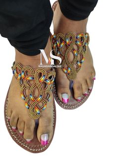 100% handmade using leather and fine beads. Masai beaded sandals are made using the pure original leather and quality African beads.They are inspired by the Masai community They are perfect for any occasion. True to size. We ship worldwide. Feel free to send me a convo for any clarifications Handmade Brown Toe Ring Sandals, Handmade Brown Toe Loop Flip Flops, Handmade Brown Flip Flops For Vacation, Traditional Adjustable Toe Post Sandals, Traditional Closed Toe Barefoot Sandals For Beach, Traditional Adjustable T-strap Sandals For Vacation, Traditional Adjustable Brown Flip Flops, Traditional Handmade Brown Flip Flops, Gold Bohemian Open Toe Sandals