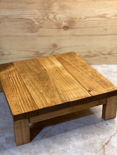 a wooden table sitting on top of a white counter