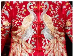 the back of a red jacket with gold and silver peacocks on it