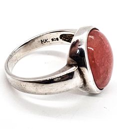 Badavichi Rhodonite pink gemstone signed vintage sterling silver ring. Good vintage condition with little to no signs of normal vintage wear. Beautiful pink Rhodonite color. Bezel set stone in solid sterling silver setting. Stamped Badavichi HK 925 on the inside of the band. Acid tests positive for sterling silver. Ring measures size 10. Vintage Large Moonstone Ring In Sterling Silver, Vintage Sterling Silver Rings With Large Stone, Vintage Sterling Silver Ring With Large Stone, Handmade Vintage Pink Rings, Pink Moonstone Sterling Silver Ring For Anniversary, Vintage Round Rings With Large Stone, Hallmarked Pink Round Rings, Vintage Pink Cabochon Ring, Vintage Pink Hallmarked Rings