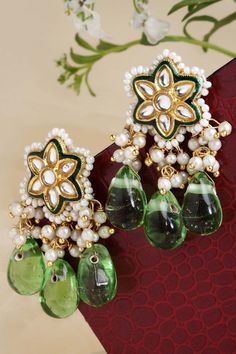 Product Features: Color: Green, Gold, White Base Material: Sterling Silver Plating: Gold-Plated Gemstones Used: Kundan, Pearls, Natural Stones, Faux Emerald Size: Freesize Dimension: Length of Earring= 5 CM; Width of Earring =3 CM; Adjustable - No Occasion: Casual Product Type: dangler Earring Disclaimer: There will be slight difference in digital to actual image Green Kundan Beaded Earrings, Earrings With Pearls, Dangler Earrings, Buy Earrings, Hand Bracelet, Kundan Earrings, Jhumka Earrings, Silver Work, Online Earrings