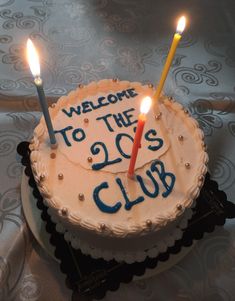 a birthday cake with candles on it that says welcome to the two's club