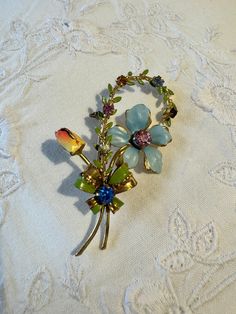 Beautiful and delicate 1930s Enamel Flower and Rhinestone Brooch Pin in a Gold Plated setting. Pastel flowers set bloom to shape the gold tone brooch with enamel flowers and prong set crystal accents. Safety clasp pin back. Measures 6.5cm x 4cm. In good vintage condition with no missing stones. Vintage Enamel Flower Brooches, Vintage Enamel Flower Brooch, Gold Brooch, Pastel Flowers, Enamel Flower, Rhinestone Brooches, Flower Brooch, Prong Setting, The Gold