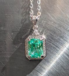 "stones were examined by a certified gemologist. Elevate Your Style with Our 9x7mm Sea Foam Green Spinel Pendant and Halo Experience the allure of natural beauty with our captivating 9x7mm Sea Foam Green Spinel Pendant, elegantly accented by a mesmerizing halo design. This pendant is a true embodiment of timeless elegance and sophistication. 🌟 Key Features: 💎🌊Genuine Sea Foam Green Spinel: Adorned with a genuine 9x7mm Sea Foam Green Spinel, prized for its unique and enchanting color reminiscent of ocean waves. 💎🌊Mesmerizing Halo Design: The exquisite halo setting enhances the Spinel's radiance, framing it with a circle of sparkling brilliance that draws attention from every angle. 💎🌊Versatile Elegance: Perfect for both formal occasions and everyday wear, this pendant effortlessly co Elegant Emerald Cut Gemstones With Accent Stones, Gia Certified Elegant Emerald Gemstones, Elegant Gia Certified Emerald Gemstones, Green Moissanite Radiant Cut Jewelry, Green Moissanite Jewelry In Radiant Cut, Green Moissanite Jewelry With Radiant Cut, Green Radiant Cut Moissanite Jewelry, Gia Certified Octagon Moissanite Jewelry, Elegant Emerald Gemstones With Accent Stones