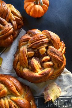 some very tasty looking pastries sitting on a towel with pumpkins in the background