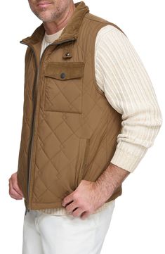 Water-resistant construction and a quilted body offer exceptional comfort in a rugged, versatile vest. 27" length Stand collar Water-resistant 100% polyester Machine wash, tumble dry Imported Sleeveless Brown Outerwear For Outdoor, Brown Vest Outerwear For Outdoor Activities, Brown Sleeveless Vest For Outdoor Activities, Quilted Functional Vest For Fall, Functional Quilted Vest For Fall, Quilted Nylon Vest For Cold Weather, Quilted Nylon Vest For Fall, Quilted Sleeveless Vest For Outdoor, Outdoor Sleeveless Quilted Vest