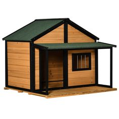 a small wooden house with a green roof and black trim on the top part of it