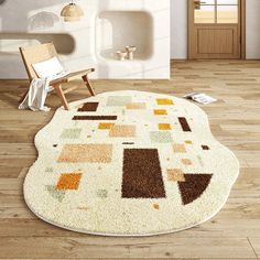 a white rug with brown and yellow squares on it in a room next to a chair