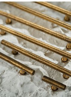 six brass handles on white paper with gold knobs