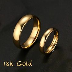 two gold wedding rings sitting next to each other on a black surface with the words 18k gold