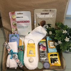 an assortment of personal care items in a cardboard box next to a potted plant