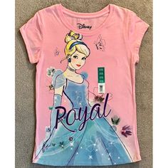 This Disney Princess Cinderella Royal T-Shirt Is Perfect For Any Little Girl Who Loves All Things Disney. Featuring A Beautiful Pink Color And A Size X-Large Fit, This Shirt Is Sure To Make Any Fan Happy. The Shirt Is Brand New, Never Worn, And Ready To Be Added To Any Collection. The Shirt Is Suitable For Girls And Is Part Of The Disney Franchise. It Can Be Worn To Show Off Your Love For Cinderella Or Even Just As A Comfortable And Stylish Everyday Shirt. Add This T-Shirt To Your Collection Of Casual Pink Shirt For Disney Fan Events, Pink Cartoon Print Top For Disney Fan Events, Fitted Short Sleeve Themed Tops, Playful Pink Top For Disney Fan Events, Pink Themed Crew Neck Tops, Pink Crew Neck Themed Tops, Disney Pink Tops With Cartoon Print, Pink Cotton Disney Top, Disney Pink Tops With Character Print