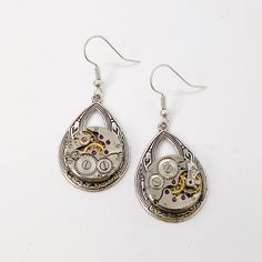 Small Helen Drop Round watch movement dangle earrings . These unique watch dangles are sure to be a great conversation starter! Wear them everyday or on special occasions, people will be intrigued by the genuine vintage watch parts in the design! They will make a splendid gift for any lady who loves all things Victorian. The watch pieces come from authentic salvaged antique watch parts. The parts are soldered into the design, which also incorporates boho style oval drop on hypoallergenic stainle Nickel Free Stainless Steel Drop Earrings, Nickel-free Stainless Steel Drop Earrings, Gift Stainless Steel Drop Earrings, Stainless Steel Teardrop Earrings For Gift, Teardrop Stainless Steel Earrings For Gifts, Steampunk Silver Dangle Jewelry, Silver Steampunk Dangle Jewelry, Steampunk Style Dangle Jewelry, Steampunk Dangle Earrings For Pierced Ears