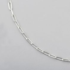 close up of sterling silver chain with diamond cut  paperclip links Sterling Silver Paperclip Bracelet With Solid Link, Sterling Silver Paperclip Bracelet With Solid Link Construction, Silver Oval Link Chain Bracelet With Cable Detail, Silver Cable Chain Bracelet With Oval Links, Silver Necklace With Solid Link Construction, Silver Link Necklace With Solid Construction, Silver Oblong Everyday Jewelry, Classic Silver Cable Chain Bracelet, Everyday Silver Oblong Jewelry