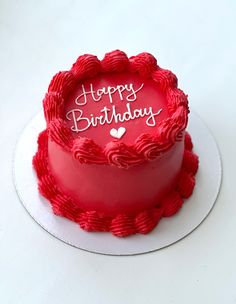 a red birthday cake with the words happy birthday written on it's frosting