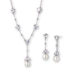 Pearl and CZ Bridal Jewelry Set This elegant bridal necklace and earring set features sparkling trillion cut cz crystals and light ivory pearl drops. The silver rhodium plated necklace has a center drop measuring 1 1/2" high and features an 8mm pearl. The matching pierced earrings measure 1 ½" long with 9mm pearls. The perfect accessory to complete your elegant bridal look. Size: the necklace has a 1 1/2" long center drop. The matching drop earrings are 1 1/2" long and are for Pierced Ears. Colo Pearl Wedding Jewelry Sets, Wedding Jewelry Sets Bridal Jewellery, Bridal Pearl Necklace, Wedding Jewelry Set, Bridal Necklace Set, Pearl Jewelry Wedding, Bridal Fashion Jewelry, Pearl Jewelry Sets, Light Ivory