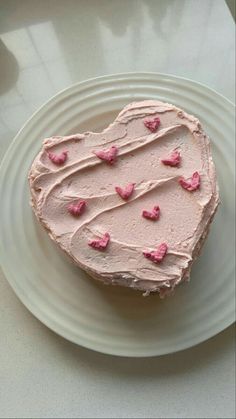 a heart shaped cake sitting on top of a white plate