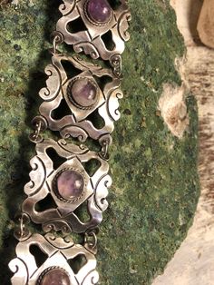 1940s Mexcian Sterling Silver Scroll Amethyst Cab Vintage Bracelet Bracelet Measures 7 inches 1 1/2 Solid in weight Vintage Adjustable Purple Jewelry, Adjustable Vintage Purple Jewelry, Vintage Silver Gemstone Bracelets, Vintage Silver Bracelets With Gemstones, Vintage Formal Gemstone Bracelet, Vintage Gemstone Bracelet For Formal Occasions, Vintage Gemstone Bracelets For Formal Occasions, Vintage Gemstone Bracelets For Formal Events, Handmade Vintage Purple Bracelets