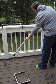 a man is cleaning the deck with a mop