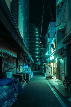 an alley at night with buildings lit up in the background