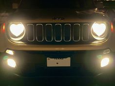 the front lights of a gold jeep with heart shaped headlights